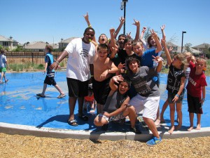 Large group of children on a splash pad at a park